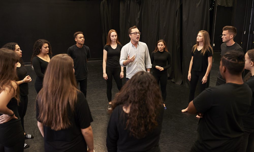 Drama Students At Performing Arts School In Studio Improvisation Class